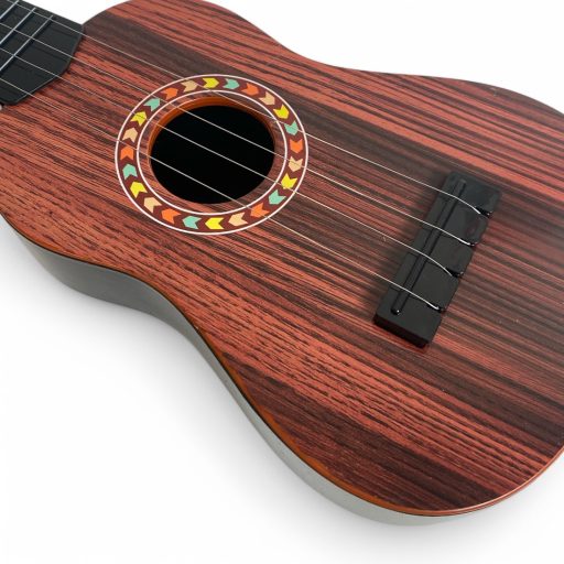 Gyermek gitár, 4 húros, 3 színben, 15x46 cm méretben.